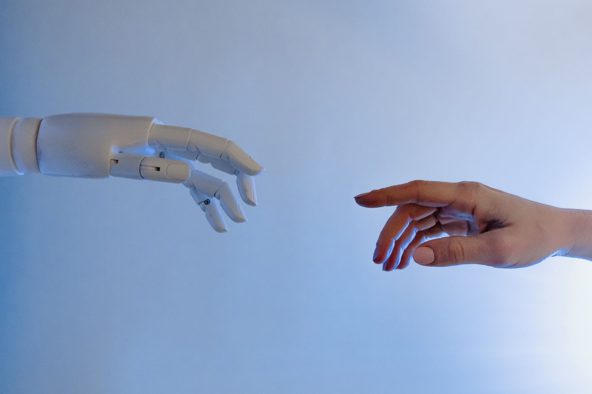 robot and human hands connecting