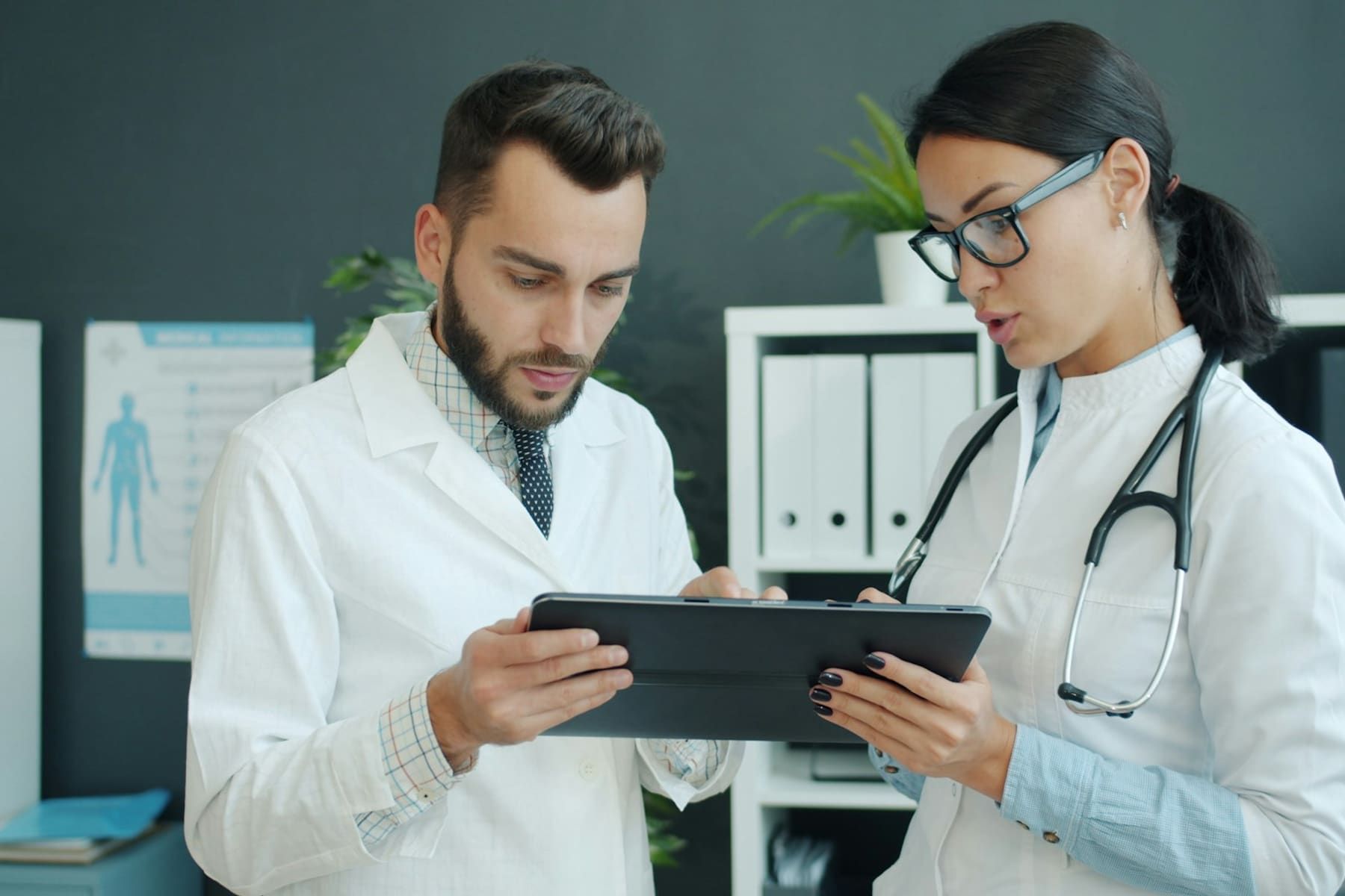 Healthcare professionals reviewing information on a tablet