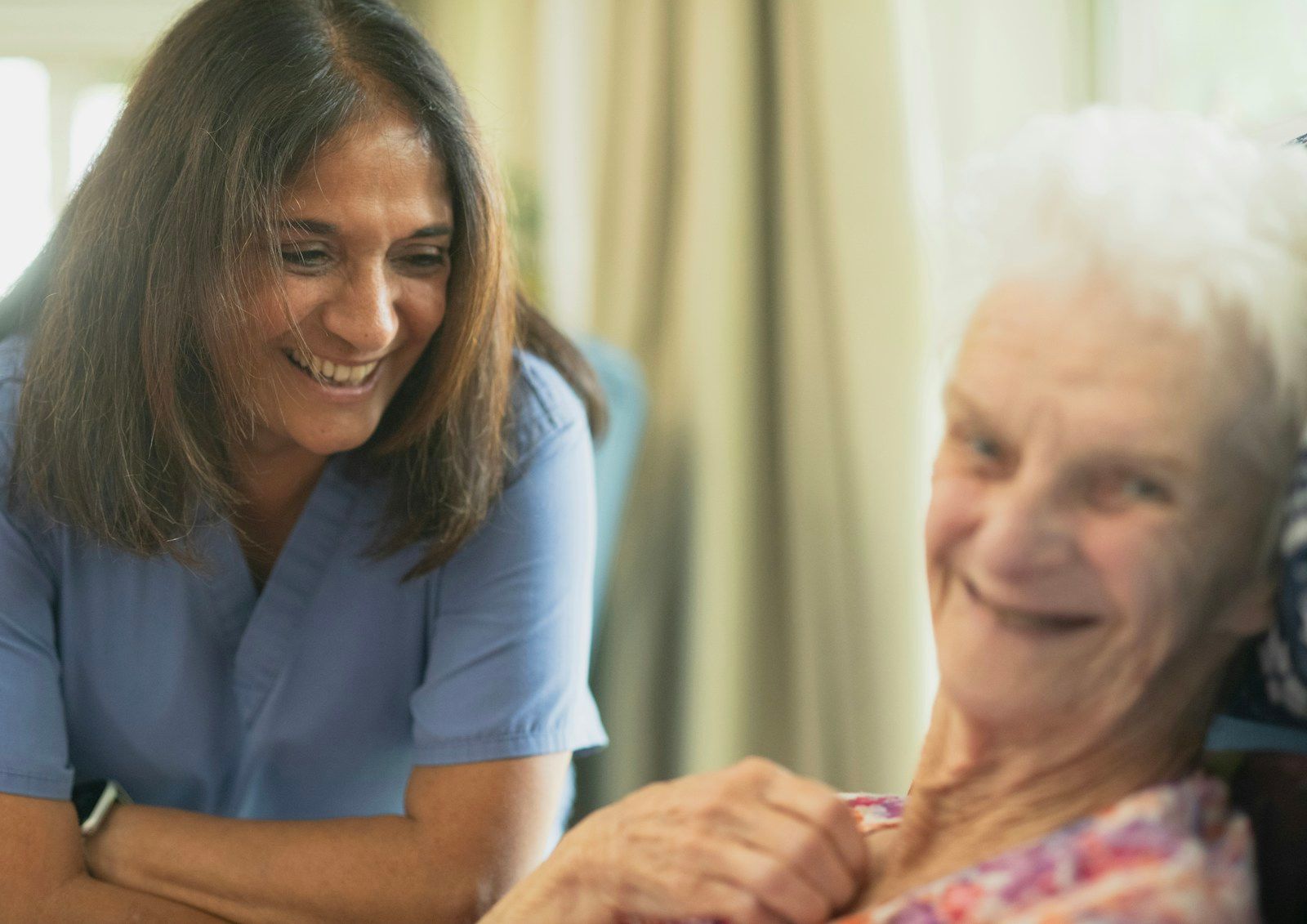 Care worker smiling with an elderly patient