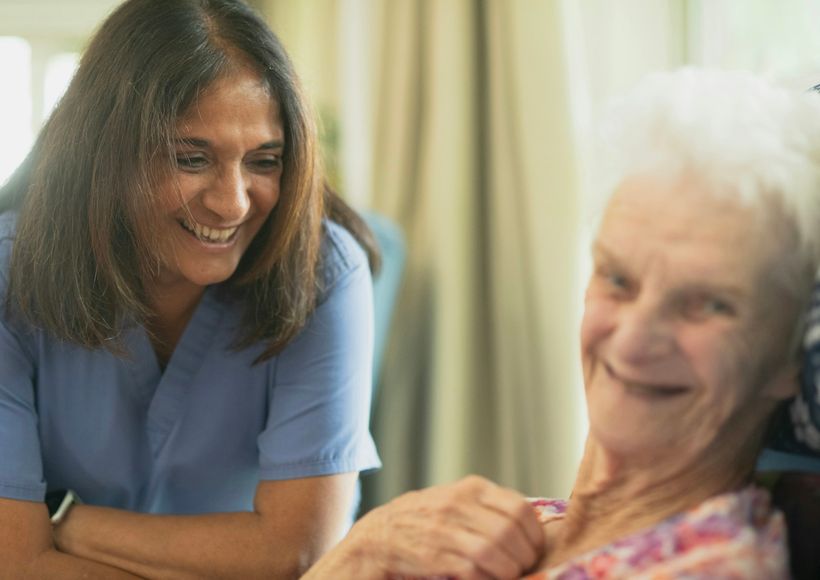 Care worker smiling with an elderly patient