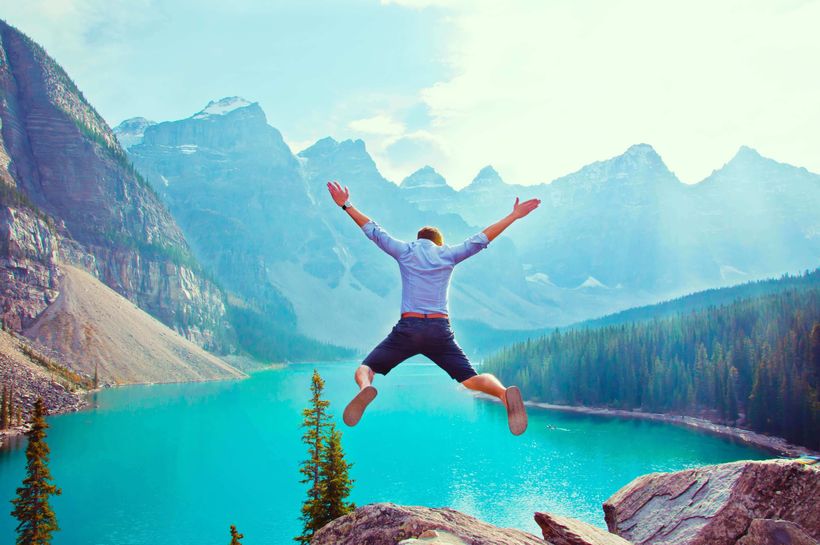 man jumping at cliff edge