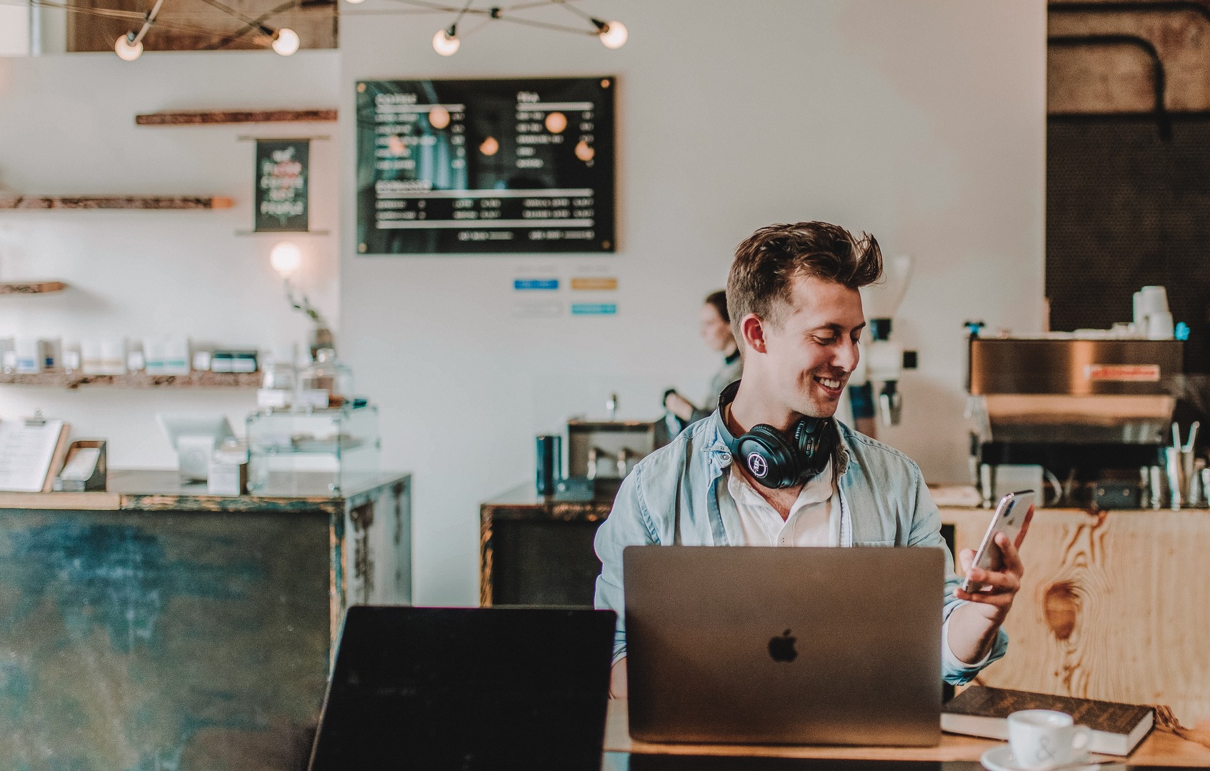 Communication is key man in cafe with mobile