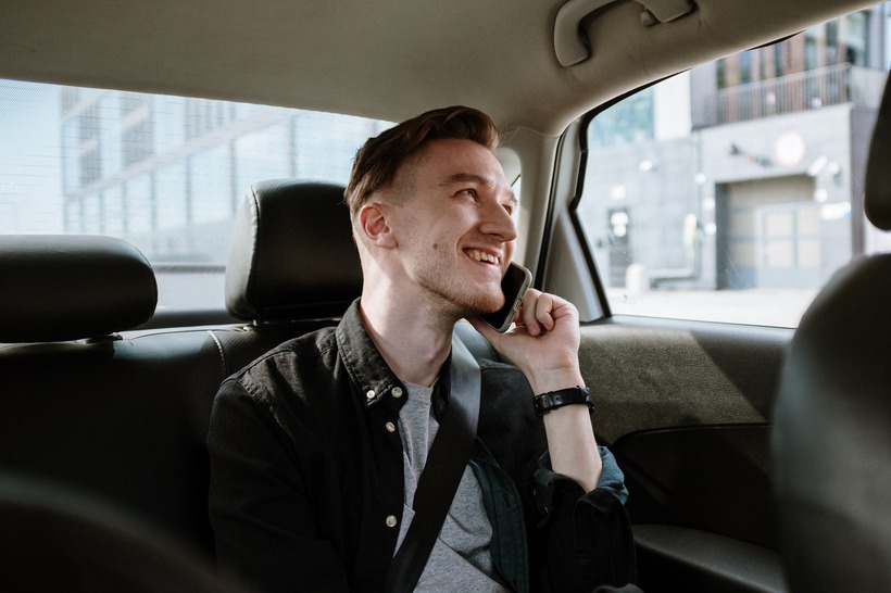 Man in taxi using mobile